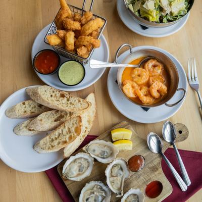 Various appetizers served on the table alongside a plate of sliced bread.