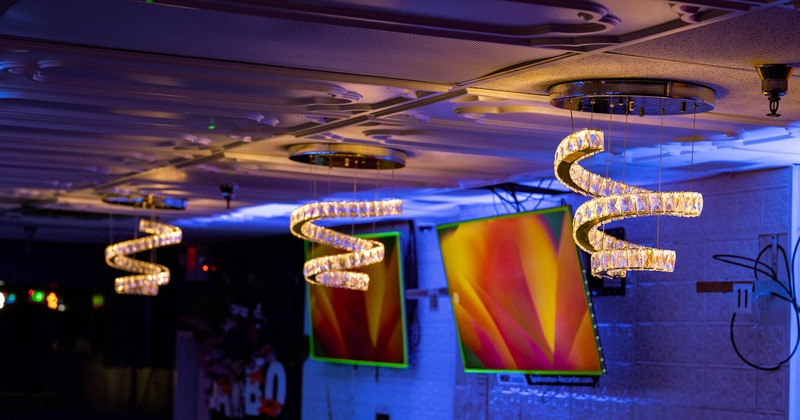 Ceiling with spiral LED chandeliers emitting warm light