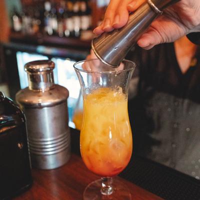 Hands preparing a drink.