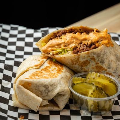 Beef burritos with lettuce, cheese, and house sauce.