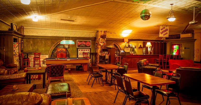 Cozy lounge seating area, tables, chairs, pool table