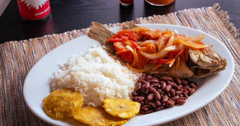 Fried fish with rice, beans, and plantains