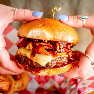 Cheeseburger with bacon, melted cheese, and barbecue sauce.