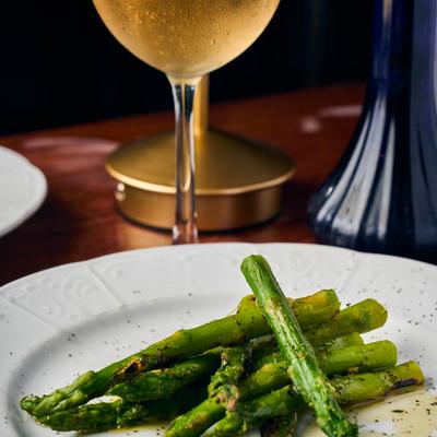 Roasted asparagus served on a white plate.