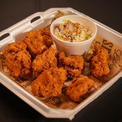 Fried chicken bites served with coleslaw.
