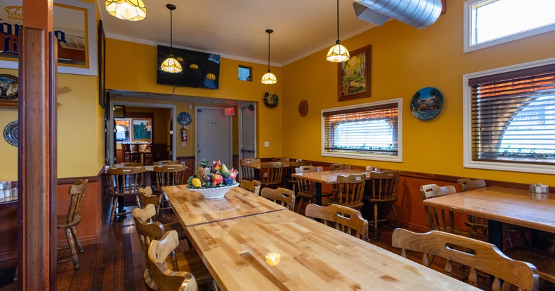 Diner table and chairs, tv screen on the wall behind