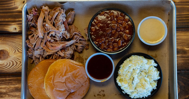 Pulled pork, baked beans, coleslaw, cheese dip, and bread