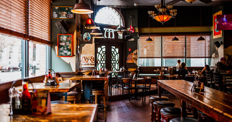 Interior, tables, stools, chairs and guests sitting