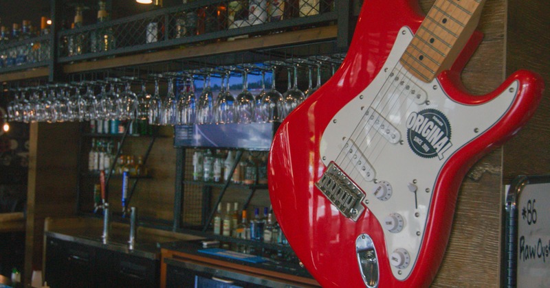 Drink rack, guitar body in front