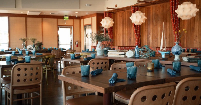 Cozy interior dining area with set dining tables ready for guests