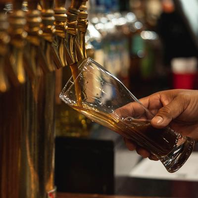 Bartender pouring beer from the tap.