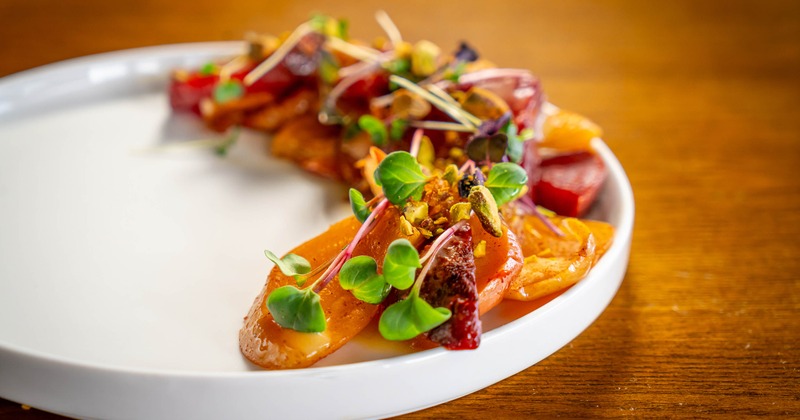 Roasted Beets dish garnished with fresh microgreens and pistachios