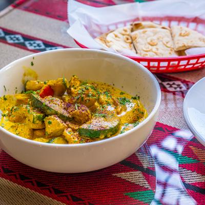 Bowl of Chicken Curry with a side of pita bread.