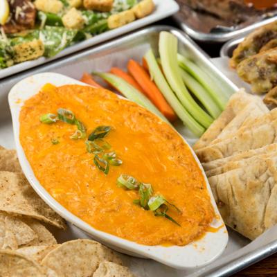 Buffalo chicken dip, served with celery, carrots, pita bread and tortilla chips.