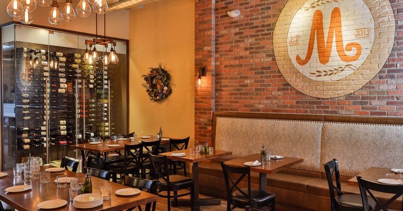 Inside, tables and chairs, restaurant's logo on the wall