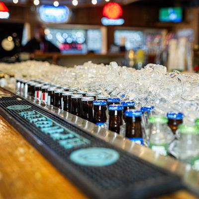Numerous bottles and glasses.
