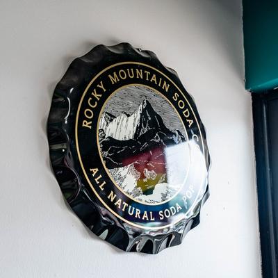 Large decorative bottle cap on a wall.
