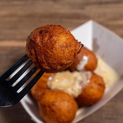 Hush Puppy on a fork, close up.