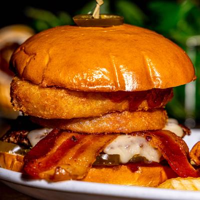 Rodeo burger topped with cheese, bacon and onion rings.