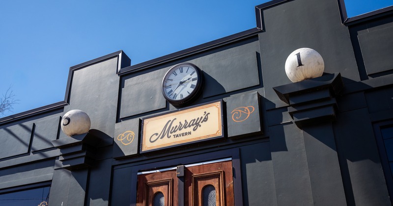 Exterior, view from below, entrance, sign and clock above