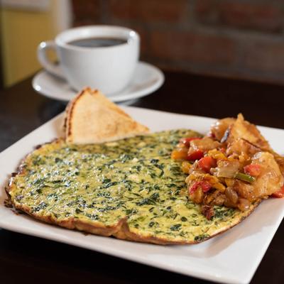 Veggie omelet served with pita and coffee.