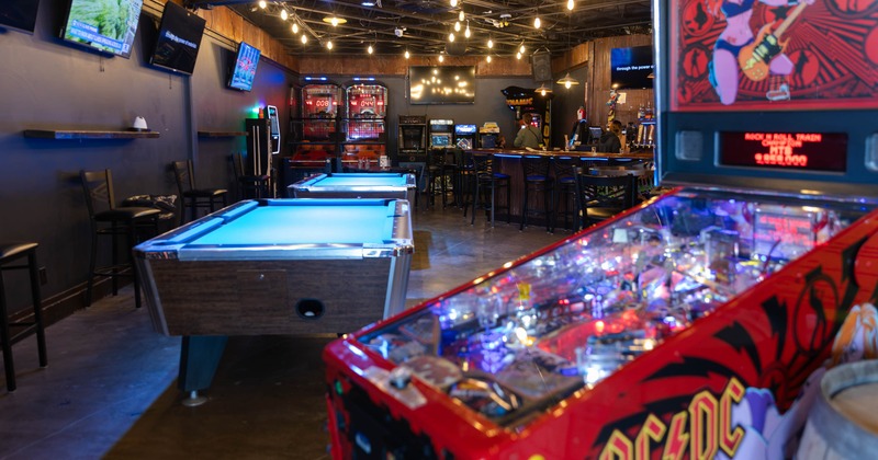 Interior, game area, AC/DC pinball machine, billiards tables in the back