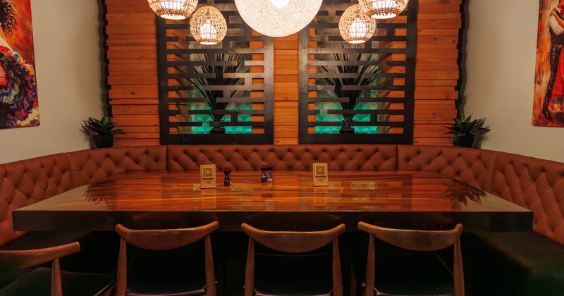 Interior, massive wooden table with large ''U'' shaped booth and four chairs