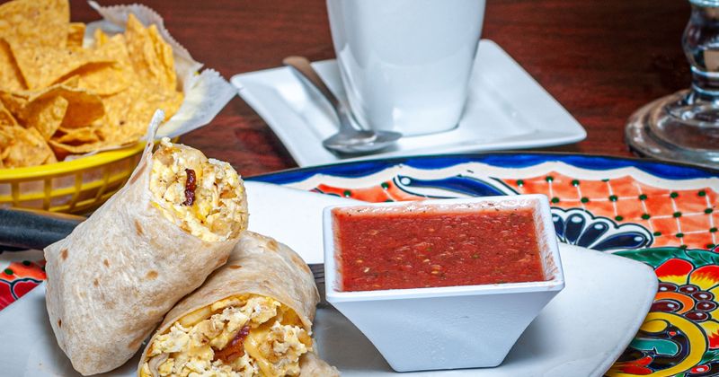 Breakfast Burrito and salsa, tortilla chips and a cup of coffee
