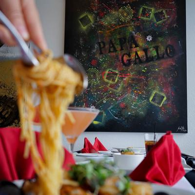 Spaghetti dish, painting in the background