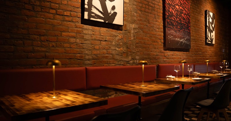 Interior seating area with chairs, tables and wall mounted benches