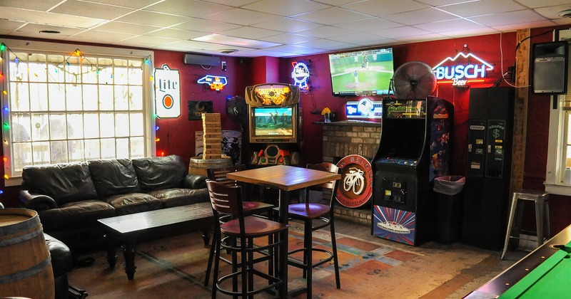 Interior, seating area with arcade machines and TV
