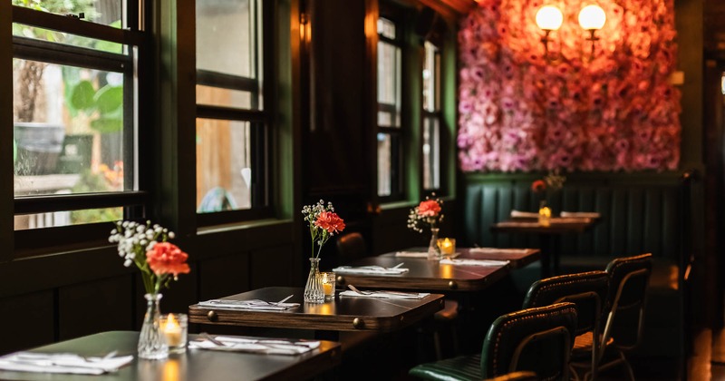 Interior, tables set for guests near windows