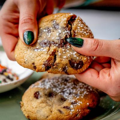 Hands holding a cookie.