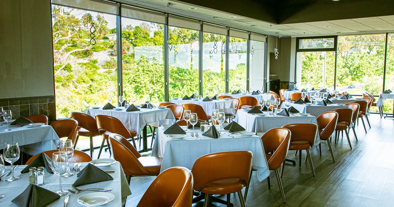 Interior, dining area with tables set for guests