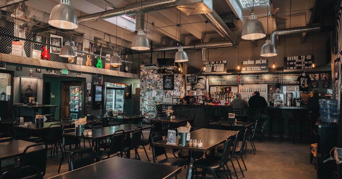 Interior, tables and chairs with bar in the back