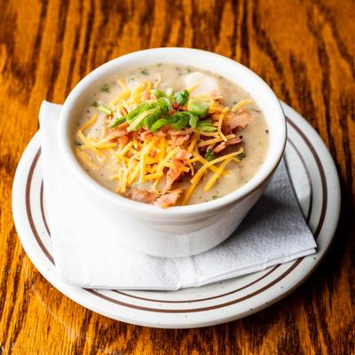 Potato Soup, topped with shredded cheese, scallions, and bacon bits.