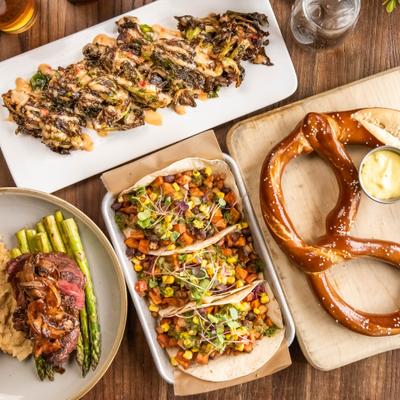 Tacos, pretzels, Miso Brussels and fillet served on table, top view