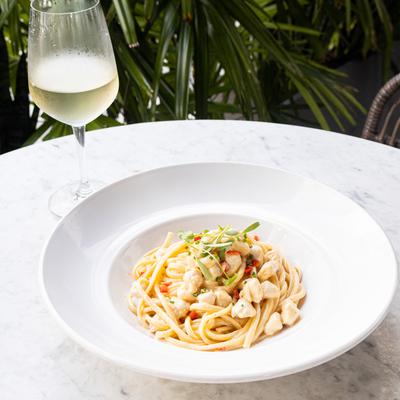 Crab pasta with glass of white wine.