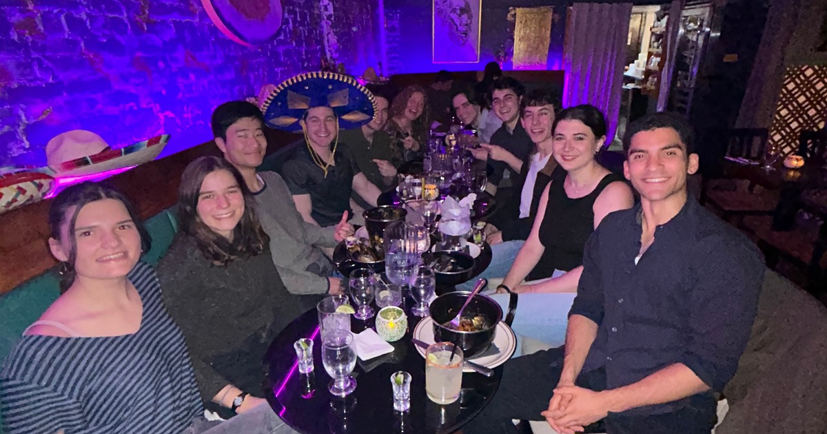 Large group gathered around a restaurant table