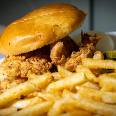 Fried chicken sandwich with fries.