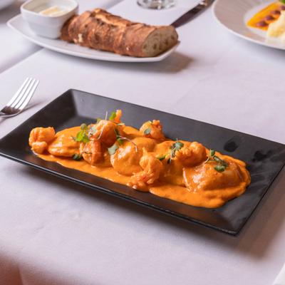 Lobster Ravioli  served on the table alongside other dishes.