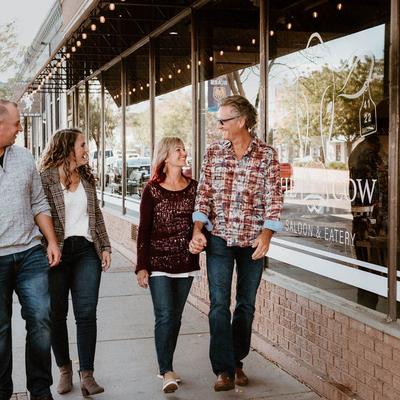 The owners walking along the restaurant's window outside