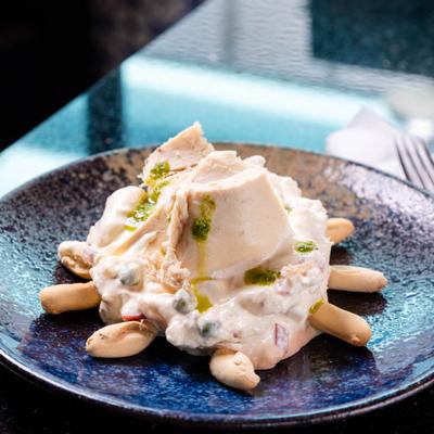 Russian salad served with with small, crunchy breadsticks.