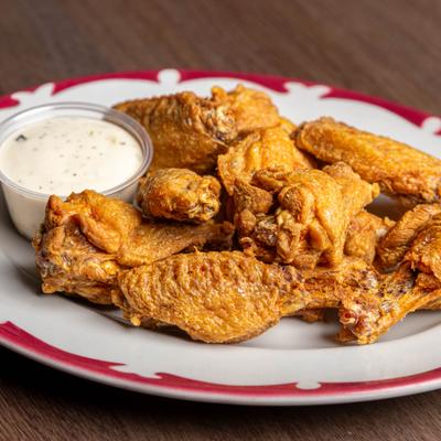 Fried chicken wings with ranch dressing.