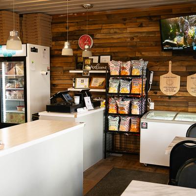 The serving counter, shelves, and the frige.