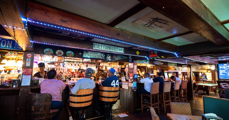 Bar, chairs, guests, tables in front