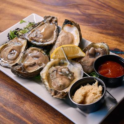 Fresh oysters with cocktail sauce.