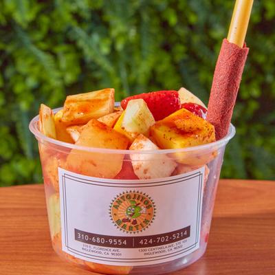 Tajin fruit cup with a tamarind candy stick.