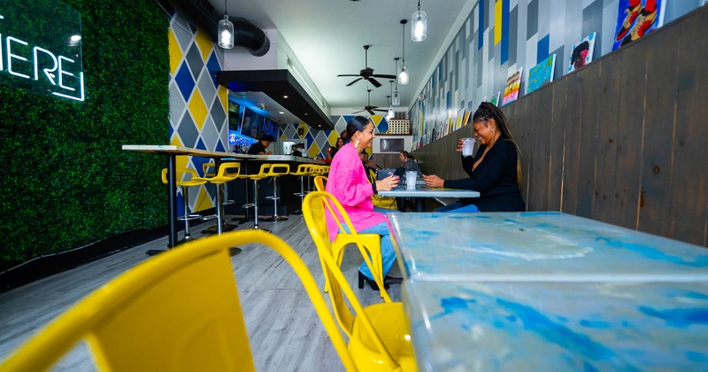 Interior, tables and chairs, guests sitting and enjoying their drinks