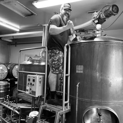 Brewmaster stirring mash in a 8 barrel mash tank.